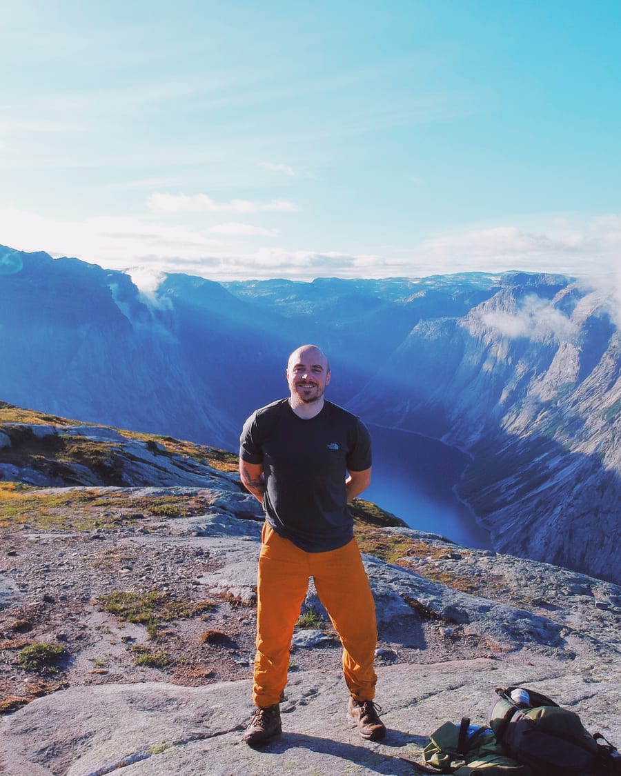 Carl on a clifftop high above the Norwegian fjords